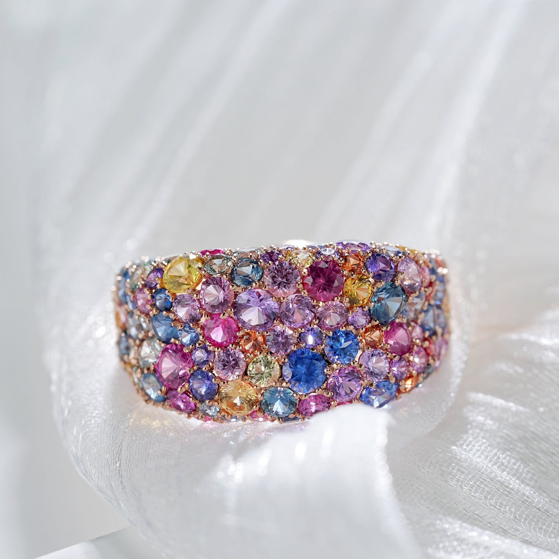 Multicolored gemstone ring on a white background