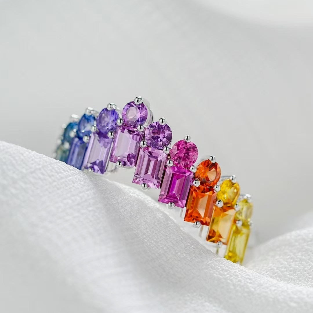 Multicolored gemstone ring on a white fabric background