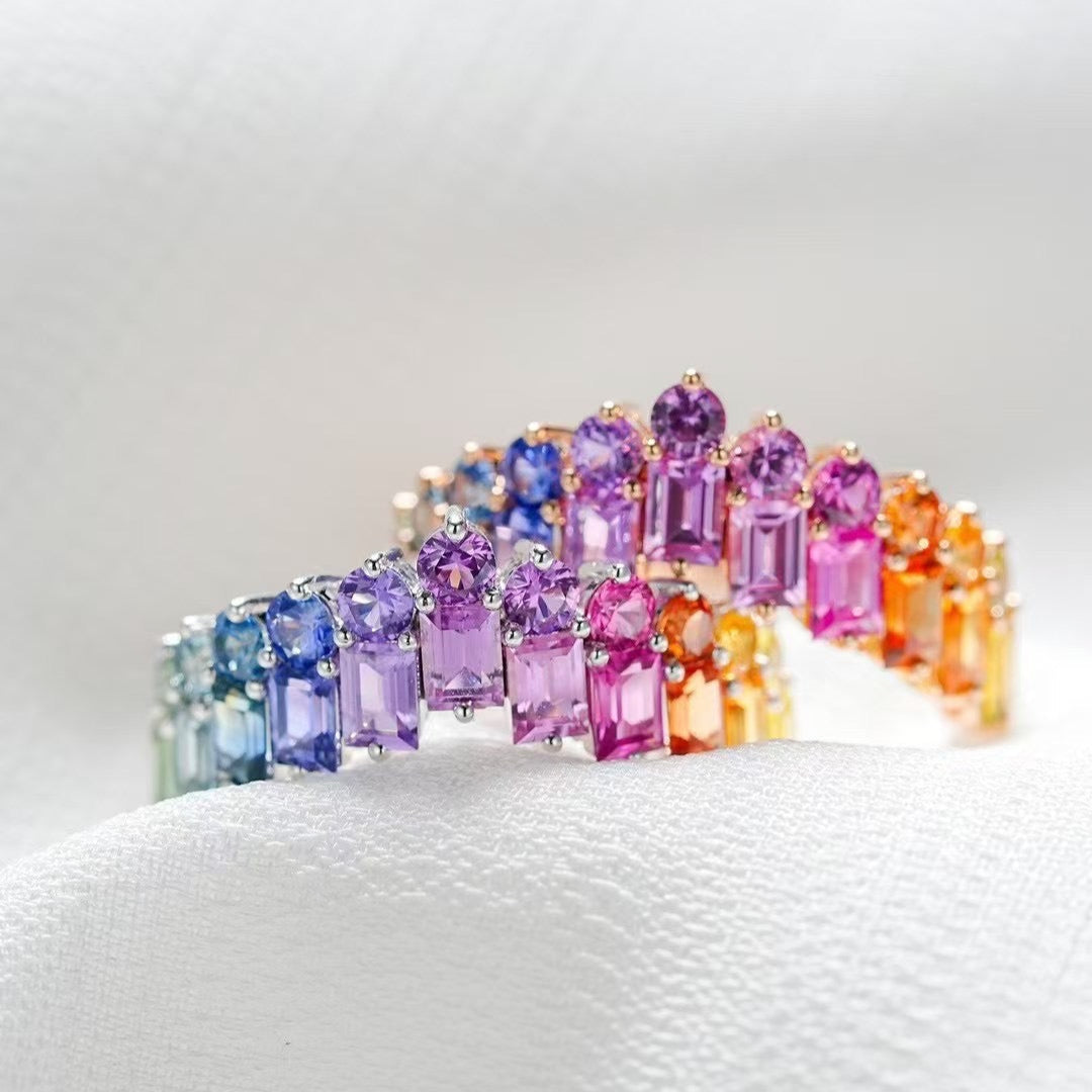 Multicolored gemstone ring on a white cushion