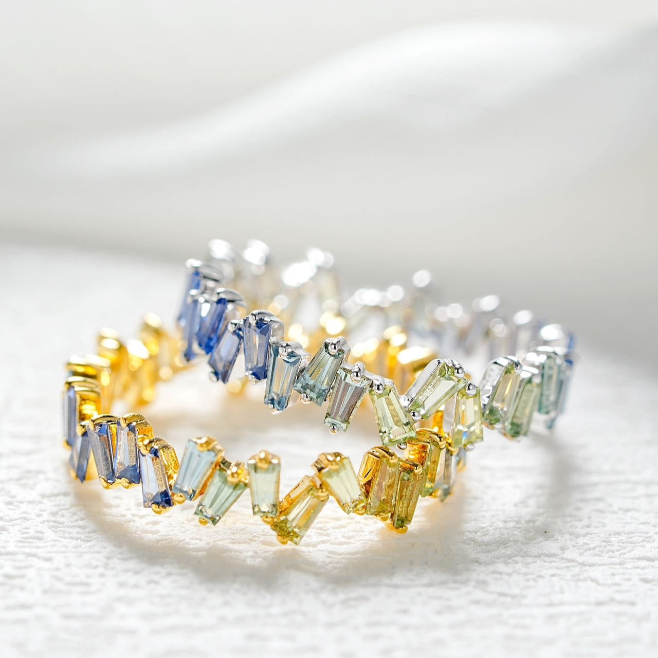 Multicolored gemstone ring on a white background