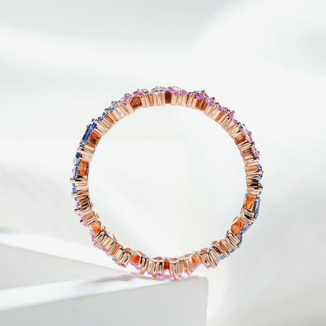 Multicolored beaded bracelet on a white surface with a light gray background