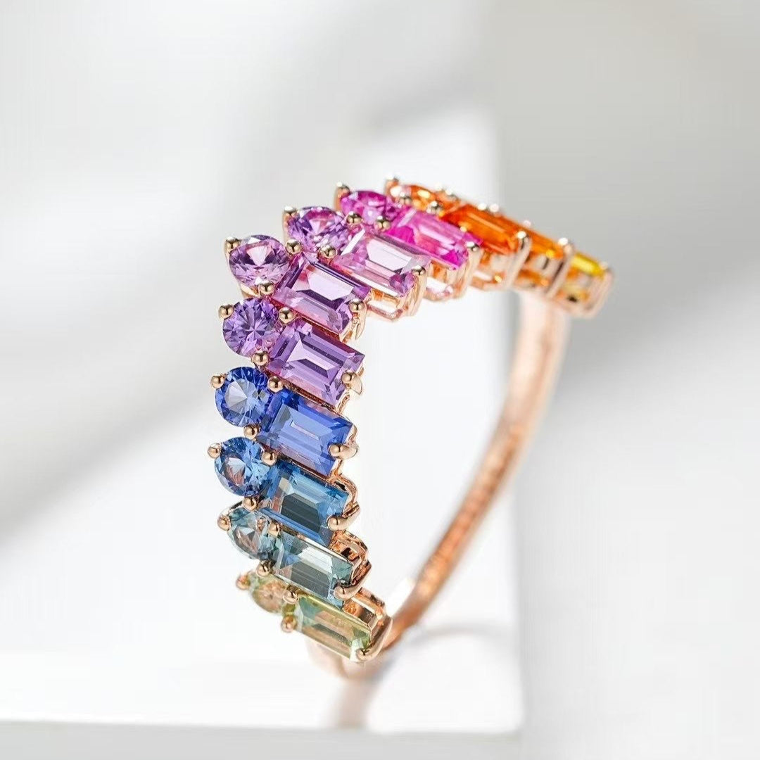 Ring with multicolored gemstones on a light background