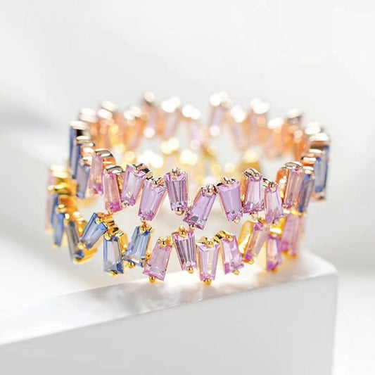 Multicolored beaded bracelet on a white surface with a light gray background